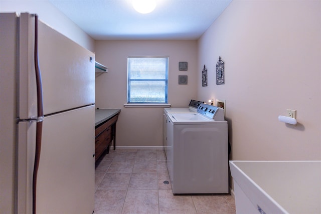 laundry room with light tile patterned floors and washing machine and clothes dryer