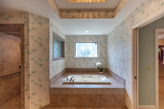 bathroom featuring independent shower and bath