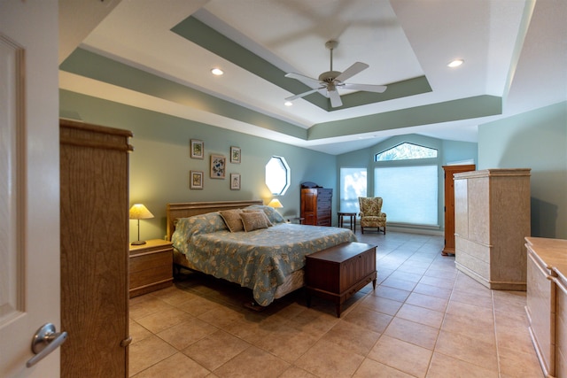 bedroom featuring light tile patterned floors, a raised ceiling, and ceiling fan