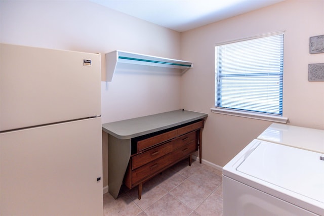 laundry room with light tile patterned flooring and separate washer and dryer