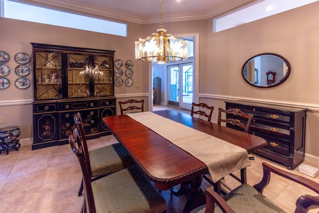 dining area featuring light tile patterned floors, crown molding, a notable chandelier, and french doors