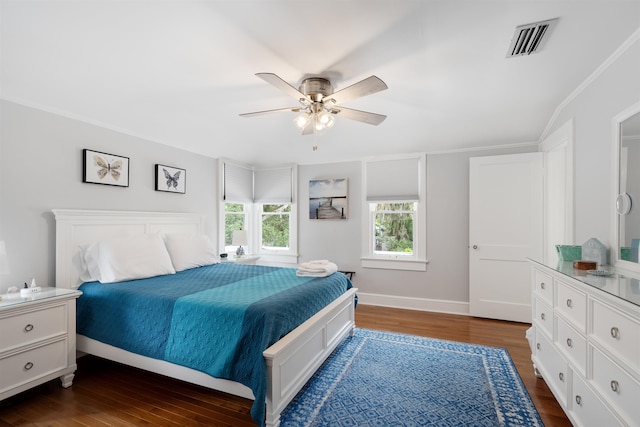 bedroom with ceiling fan, crown molding, and dark wood-type flooring