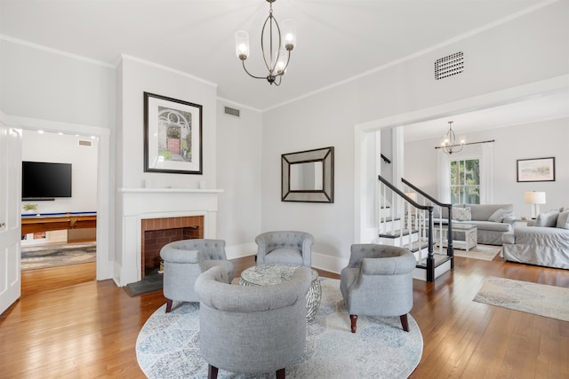 living room featuring ornamental molding, a fireplace, wood-type flooring, and pool table