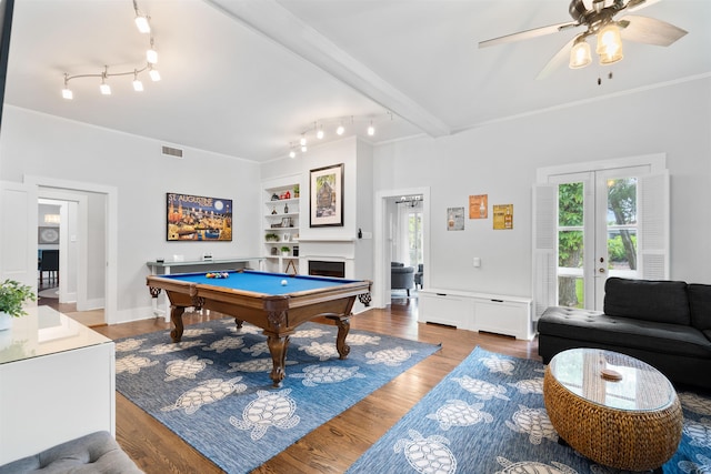 game room with beam ceiling, hardwood / wood-style flooring, ceiling fan, and billiards