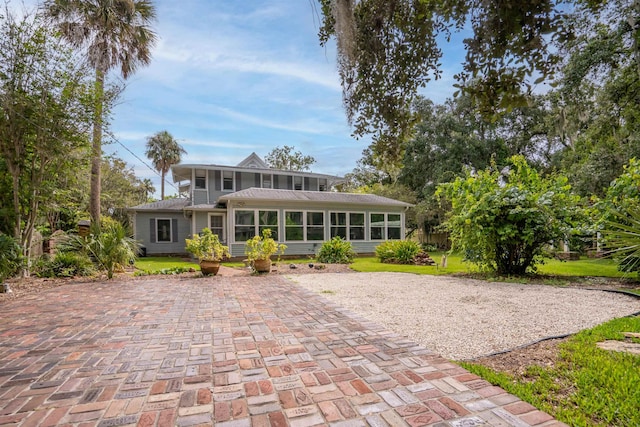 rear view of property with a sunroom