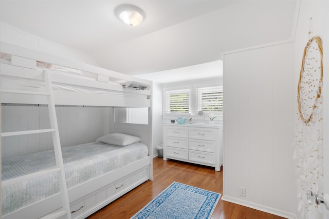 bedroom featuring lofted ceiling and light wood-type flooring