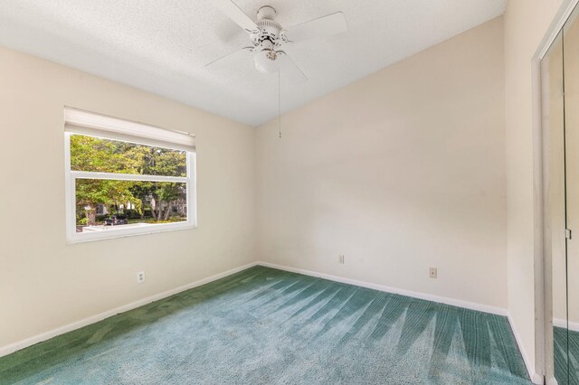 unfurnished room featuring carpet, a textured ceiling, and ceiling fan