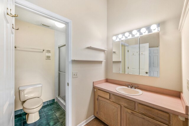 bathroom with tile patterned flooring, vanity, toilet, and an enclosed shower