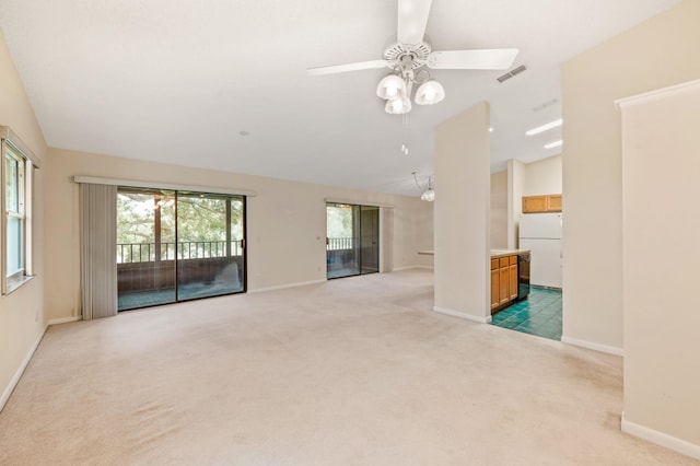 carpeted spare room with ceiling fan and lofted ceiling