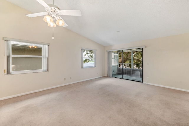 carpeted empty room featuring vaulted ceiling and ceiling fan