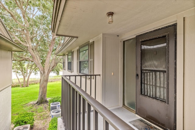 doorway to property with a lawn and central AC