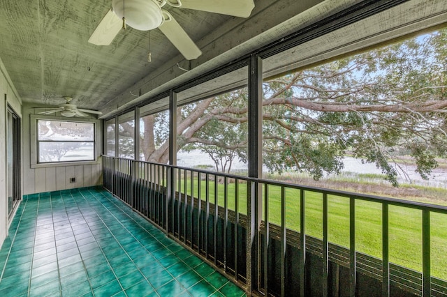 unfurnished sunroom with a water view