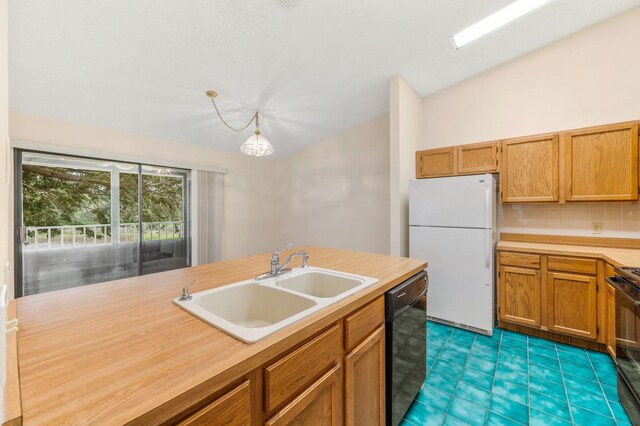 kitchen with pendant lighting, black appliances, dark tile patterned flooring, sink, and decorative backsplash