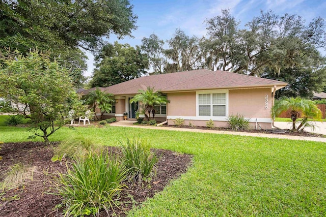 ranch-style home with a front lawn