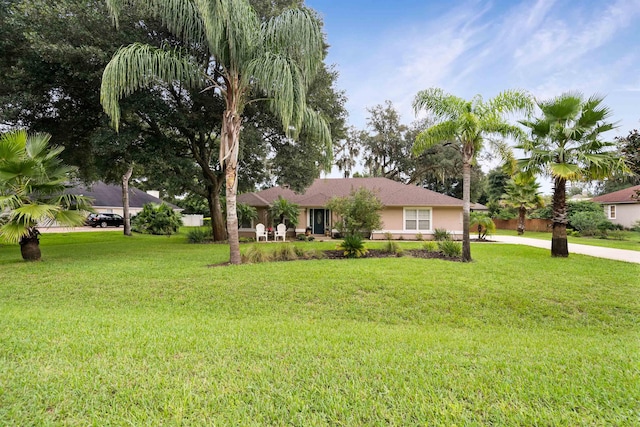 single story home featuring a front lawn