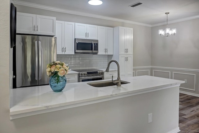 kitchen featuring light stone counters, sink, white cabinetry, and stainless steel appliances