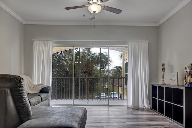 interior space featuring hardwood / wood-style floors, ceiling fan, and crown molding