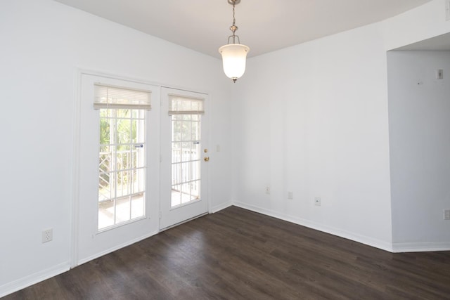 interior space featuring plenty of natural light and dark hardwood / wood-style floors