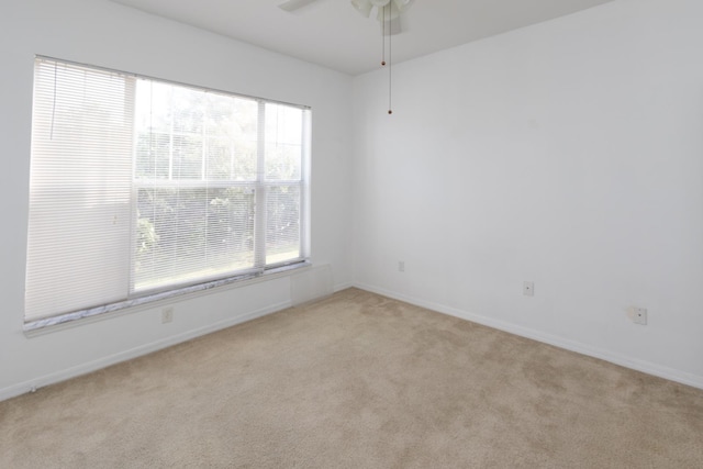 unfurnished room with ceiling fan and light colored carpet