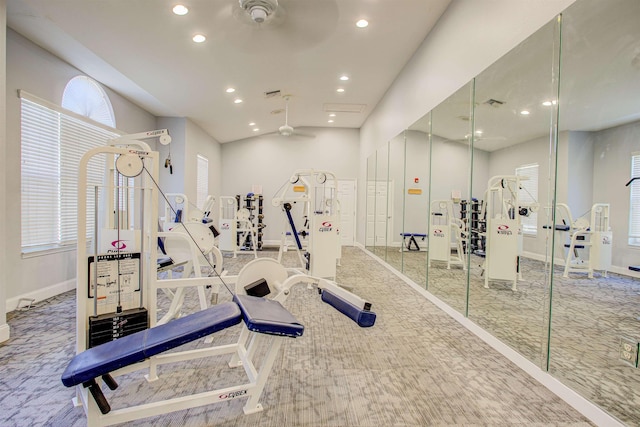 exercise room featuring vaulted ceiling, ceiling fan, and carpet