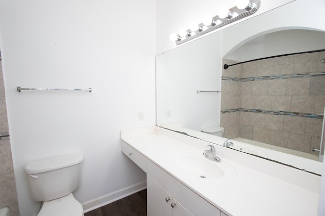 bathroom with wood-type flooring, toilet, and vanity