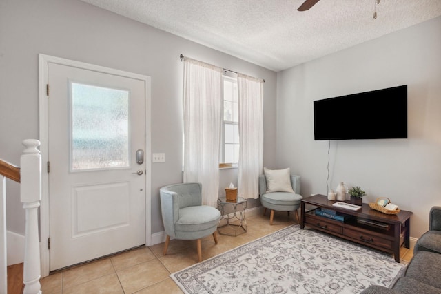 133 Pomar St, Saint Augustine, FL 32084 - living room with light tile patterned flooring, a textured ceiling, and a ceiling fan