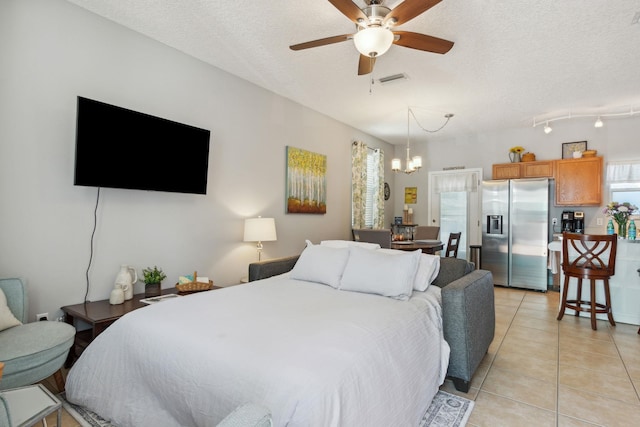 133 Pomar St, Saint Augustine, FL 32084 - bedroom with stainless steel fridge, light tile patterned floors, a textured ceiling, and a chandelier