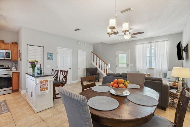 133 Pomar St, Saint Augustine, FL 32084 - dining room featuring stairs, light tile patterned floors, ceiling fan, and a textured ceiling