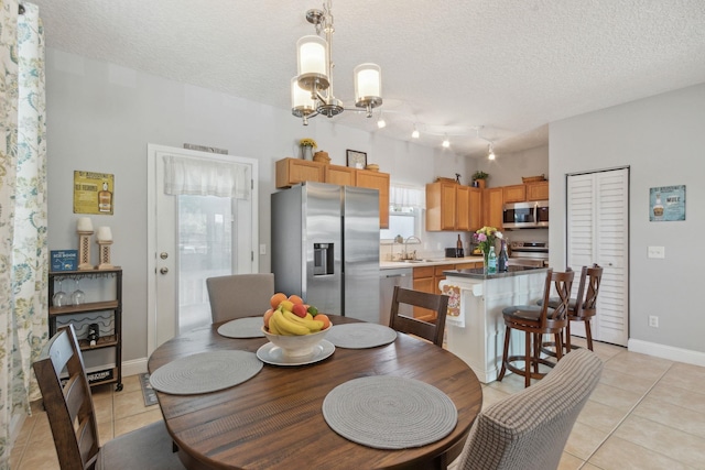 133 Pomar St, Saint Augustine, FL 32084 - dining space featuring light tile patterned flooring, a chandelier, and a textured ceiling
