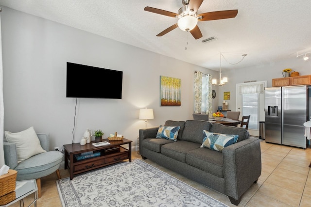 133 Pomar St, Saint Augustine, FL 32084 - living area featuring light tile patterned flooring, a ceiling fan, a textured ceiling, and a chandelier