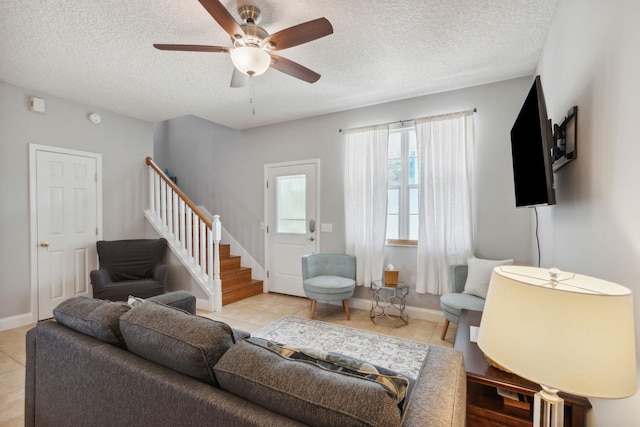 133 Pomar St, Saint Augustine, FL 32084 - living room featuring stairway, light tile patterned floors, a textured ceiling, and ceiling fan