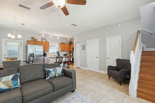 133 Pomar St, Saint Augustine, FL 32084 - living room featuring stairway, a ceiling fan, light tile patterned floors, a chandelier, and a textured ceiling