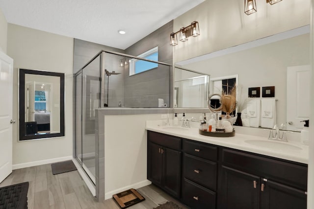 190 River Mist Dr, Saint Augustine, FL 32095 - bathroom with double vanity, a sink, a stall shower, and baseboards