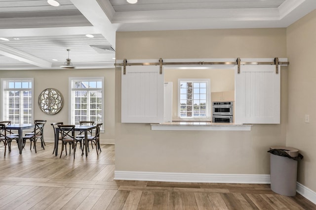 190 River Mist Dr, Saint Augustine, FL 32095 - kitchen featuring hardwood / wood-style flooring, double oven, a barn door, baseboards, and visible vents