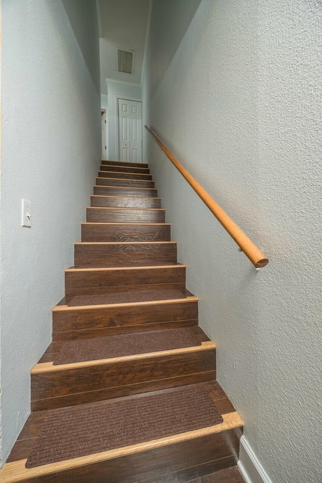 stairs featuring hardwood / wood-style flooring