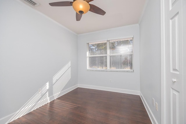 spare room with ceiling fan, crown molding, and dark wood-type flooring