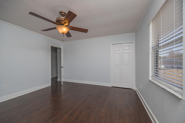 empty room featuring ceiling fan, dark hardwood / wood-style flooring, and crown molding