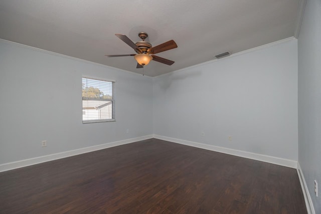 empty room featuring ceiling fan, dark hardwood / wood-style floors, and crown molding