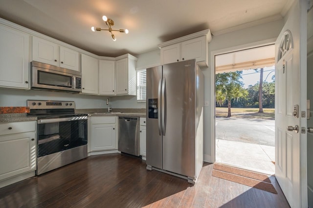 kitchen featuring a healthy amount of sunlight, white cabinetry, dark hardwood / wood-style floors, and appliances with stainless steel finishes