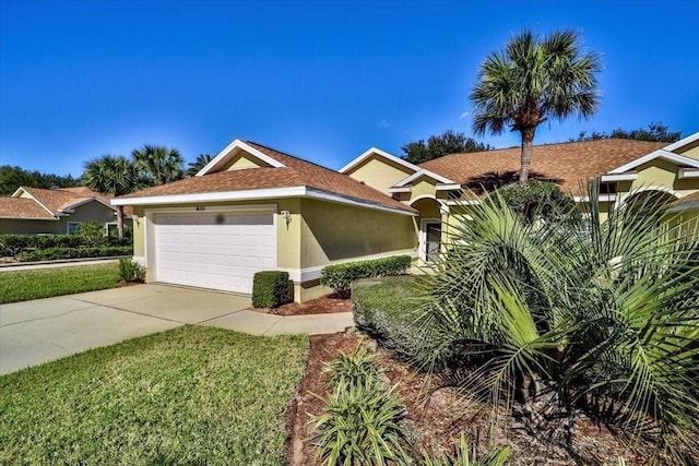 2001 Palm Dr Unit 101, Flagler Beach, FL 32136 - view of front facade with an attached garage, a front lawn, stucco siding, and driveway