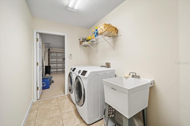 2001 Palm Dr Unit 101, Flagler Beach, FL 32136 - clothes washing area featuring laundry area, a sink, baseboards, light tile patterned floors, and washer and dryer