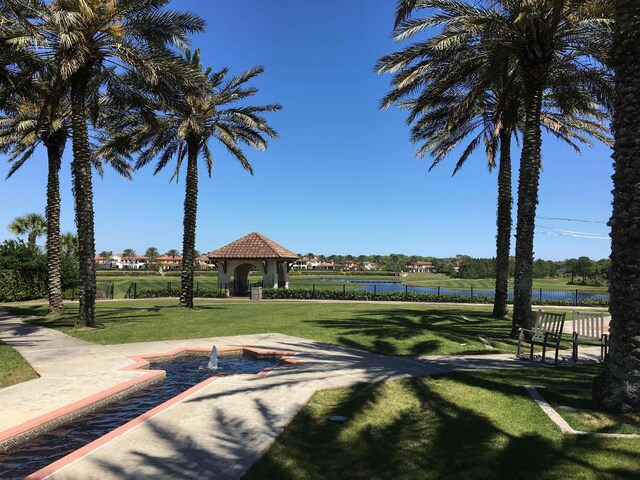 view of home's community with a gazebo, a yard, and a water view