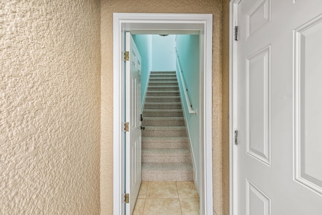 staircase with tile patterned floors