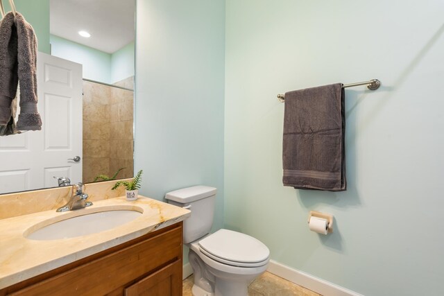 bathroom with tile patterned flooring, vanity, and toilet