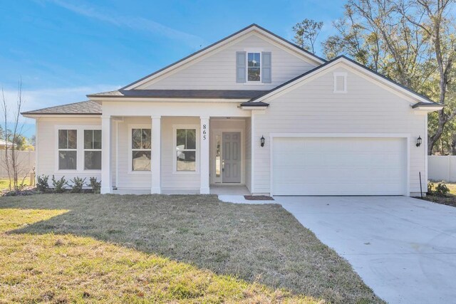 view of front of house with a porch, a front lawn, a garage, concrete driveway, and fence