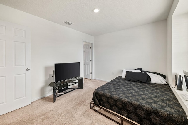 carpeted bedroom with a textured ceiling