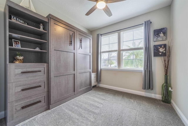 unfurnished bedroom with ceiling fan and carpet