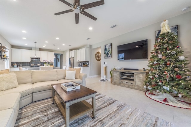 tiled living room featuring ceiling fan