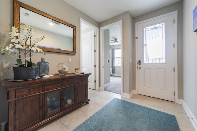 tiled foyer entrance with ceiling fan