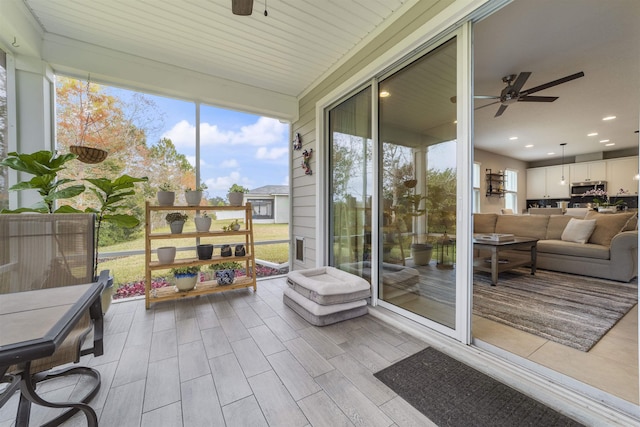 sunroom / solarium with ceiling fan